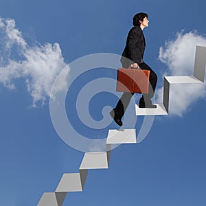 Business woman ascending stairs photo