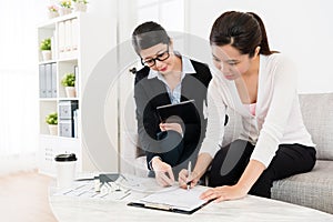 Business woman assisting client buying house