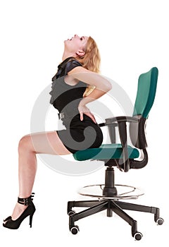 Business woman backache back pain sitting on chair. Long working hours.