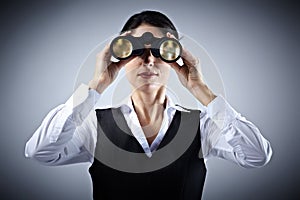 Business woman with binoculars.