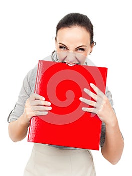 Business woman bites in a red binder