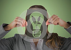 Business woman with black card over face showing green lightbulb graphic against green background