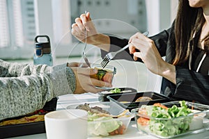 Business woman in black formal suit enjoy having lunch with business partner