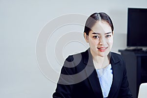 Business woman in a black suit of smiling asian young women the office.