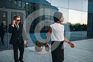 Business woman, bodyguard in suit on background