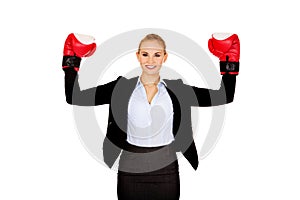 Business woman in boxing gloves standing in victory pose