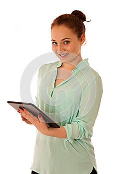 Business woman brousing the web on a tablet isolated over white