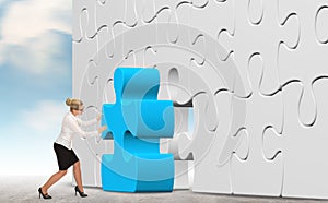 Business woman building a puzzle on a sky background