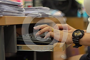 Business woman busy working on keyboard computer with paper work