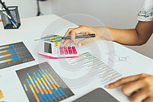 Business woman calculate about cost and doing finance at office