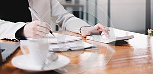 Business woman calculating domestic expenses involved in financial paperwork indoors, focused lady managing monthly banking