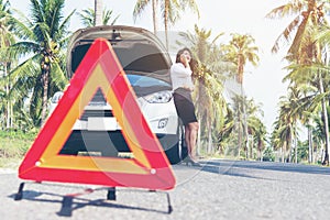 Business woman calling car insurance for assistance broken car on the road