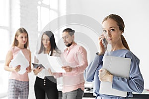 Business Woman calling on her mobile. Work in the office. Team leader. The concept of entrepreneurs, business and work on success