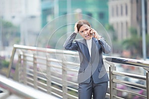 Business Woman calling the smartphone and she feel angry