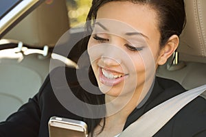 Business woman in a car looking at the camera.