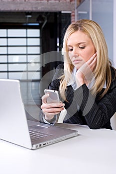 Business Woman on cell at desk