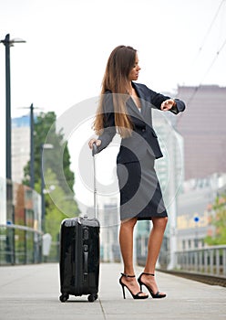 Business woman checking time at train station