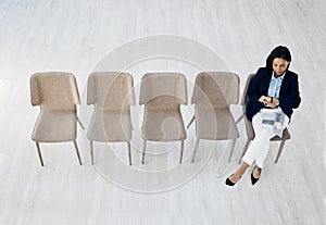 Business woman, checking watch and waiting room sitting on chairs above on mockup space at office. Top view of female