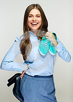 Business woman chooses footwear. Isolated portrait.