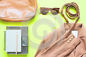 Business woman clothing and accessories in brown concept on yellow