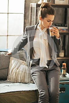 Business woman with coffee latte sitting on divan