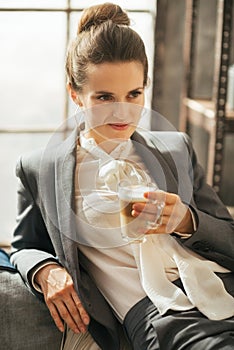 Business woman with coffee relaxing in apartment