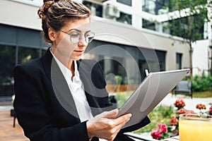 Business woman in coffee shop with gadgets