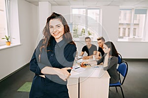 Business woman with colleagues meeting behind her