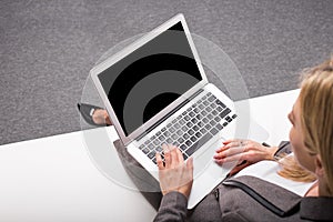 Business woman with computer in her lap