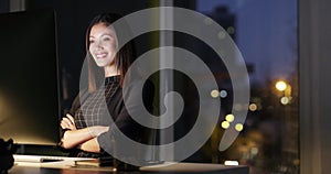 Business woman, computer and satisfied at night working a in office with pride for goals. Female entrepreneur person at
