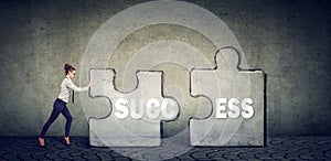 Business woman connecting elements of success puzzle photo