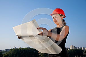 Business woman considers construction plans