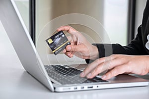 Business woman consumer holding credit card and typing on laptop for online shopping and payment make a purchase on the Internet,