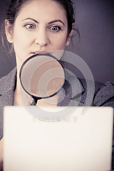 Business woman with contract and loupe