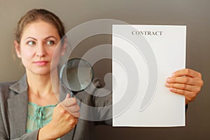 Business woman with contract and loupe