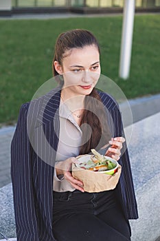 Business woman does not want to eat a salad with meat