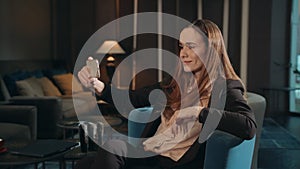 Business woman doing mobile selfie by smartphone in chair lounge room