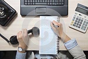 Business woman doing a note, top view