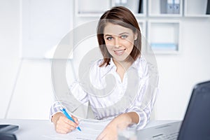 Business woman doing some paperwork in office