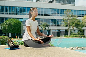 Business Woman Doing Yoga Lotus Position Outside Office Building