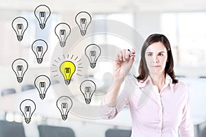 Business woman drawing a great idea concept. Office background.