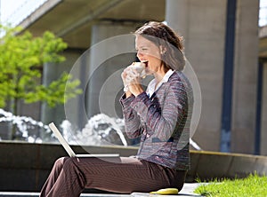 Business woman eating food during lunch break