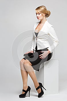 Business woman in an elegant suit sitting