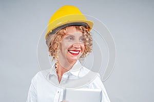 Business woman engineer in yellow safety helmet with tablet