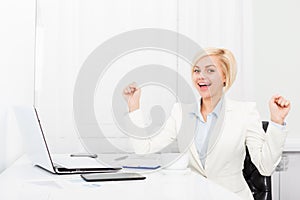 Business woman excited at modern office desk