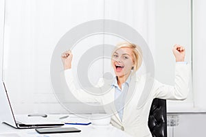 Business woman excited at modern office desk