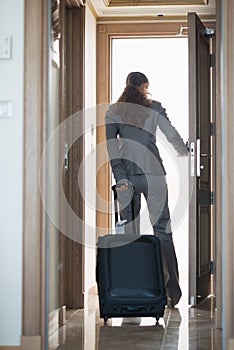 Business woman exiting hotel room . rear view photo