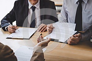 Business woman explaining about his profile to two selection committee manager sitting in during job Interview, interview the job