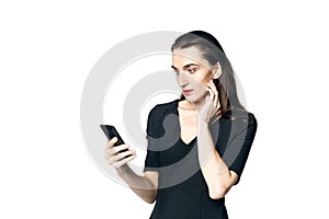 Business woman fatal woman in a black dress with red lipstick holding a smartphone