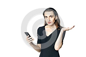 Business woman fatal woman in a black dress with red lipstick looks at her phone, isolated on a white background